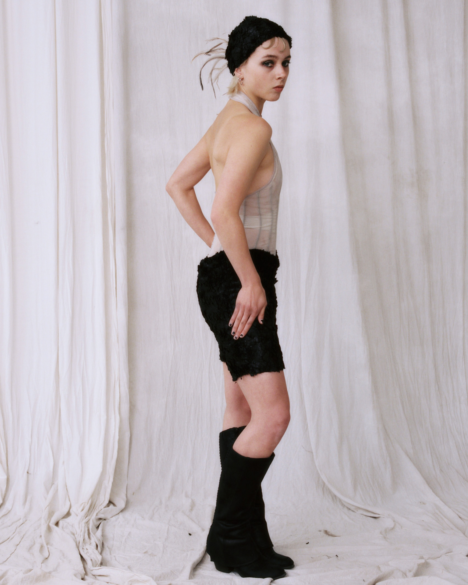 Astrakhan plume cap — side profile with emu feather detail