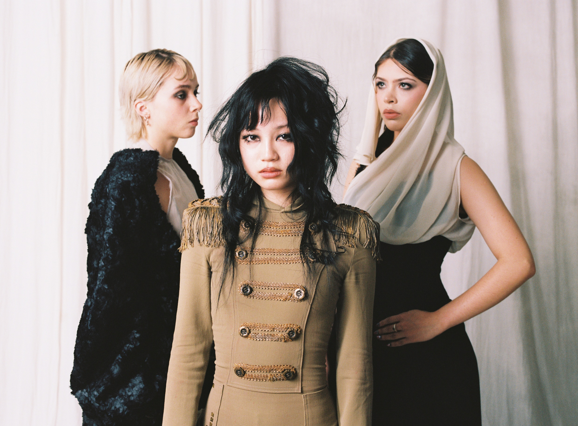 Trio portrait — Mio centered in Regiment Bodysuit between veiled and brocade looks