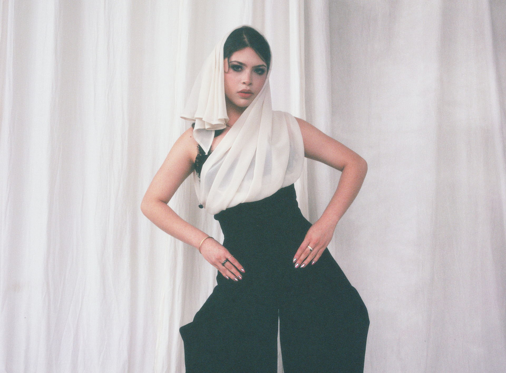 Solo veiled column look with draped ivory hood and black silhouette